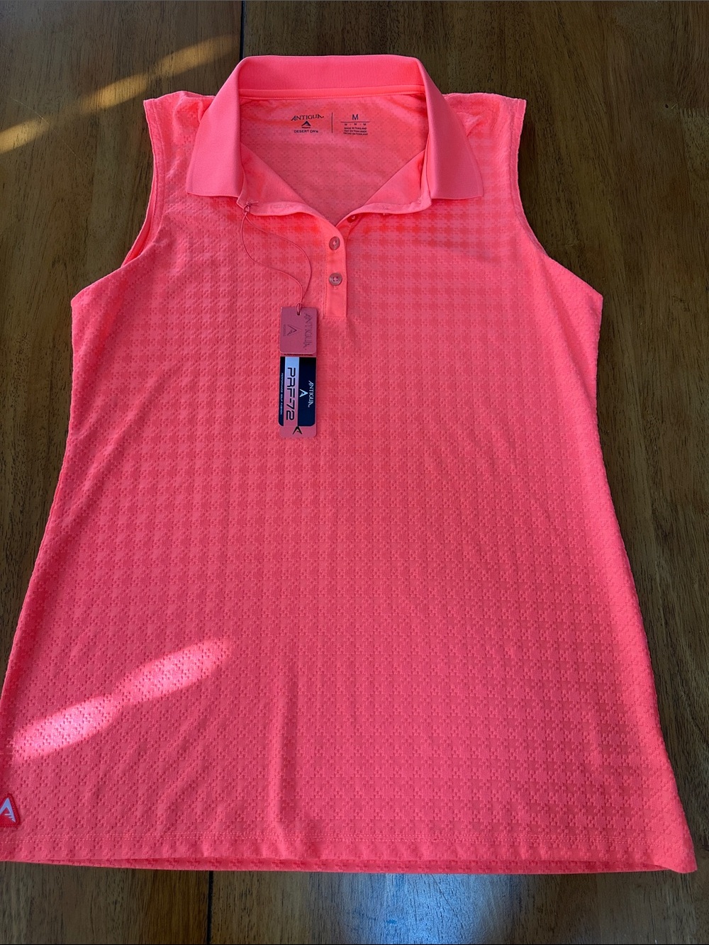 Antigua women’s golf shirt, sleeveless. Neon orange. Collared. NWT